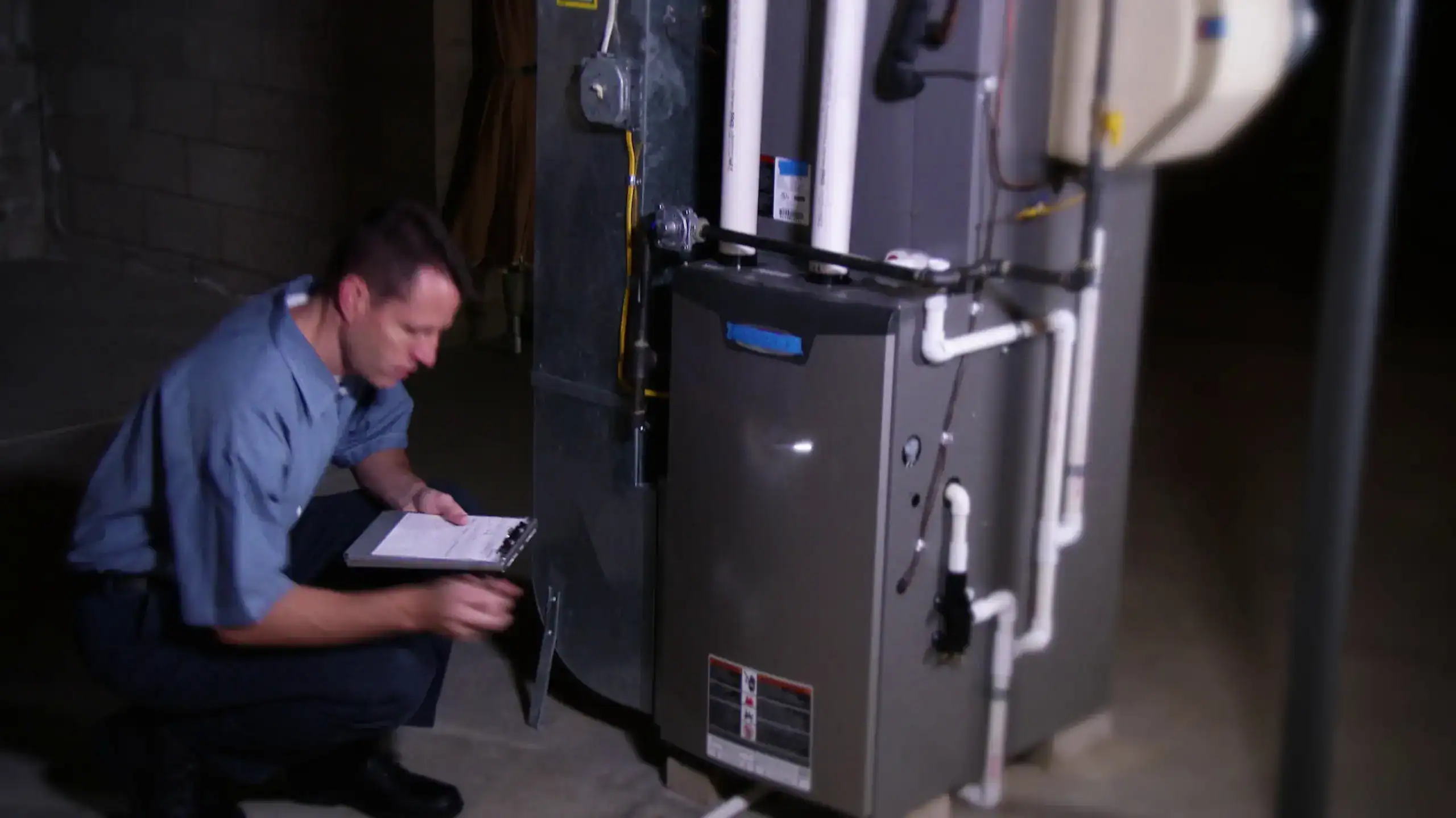 A professional technician performing maintenance on a heating system in a commercial setting.